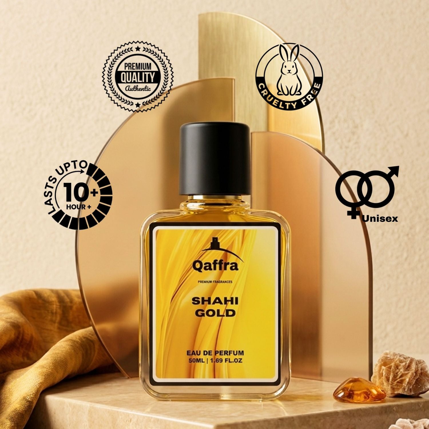 A bottle of Qaffra Shahi Gold Eau de Parfum is displayed on a wooden surface with decorative gold arches, a brown fabric, and amber crystals. The background is a textured beige wall, and several circular badges highlight product features like cruelty-free status, unisex formula, and 10-hour fragrance longevity.