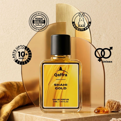 A bottle of Qaffra Shahi Gold Eau de Parfum is displayed on a wooden surface with decorative gold arches, a brown fabric, and amber crystals. The background is a textured beige wall, and several circular badges highlight product features like cruelty-free status, unisex formula, and 10-hour fragrance longevity.
