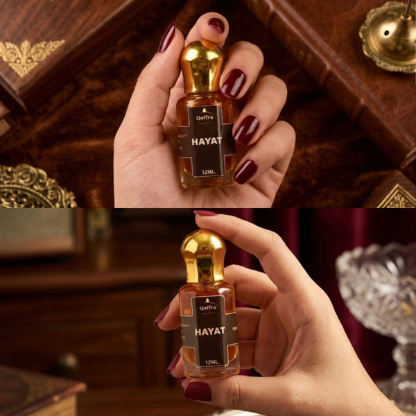 Hand holding a 12ml Long lasting Attar bottle with labeled 'Hayat' with a wooden rich background