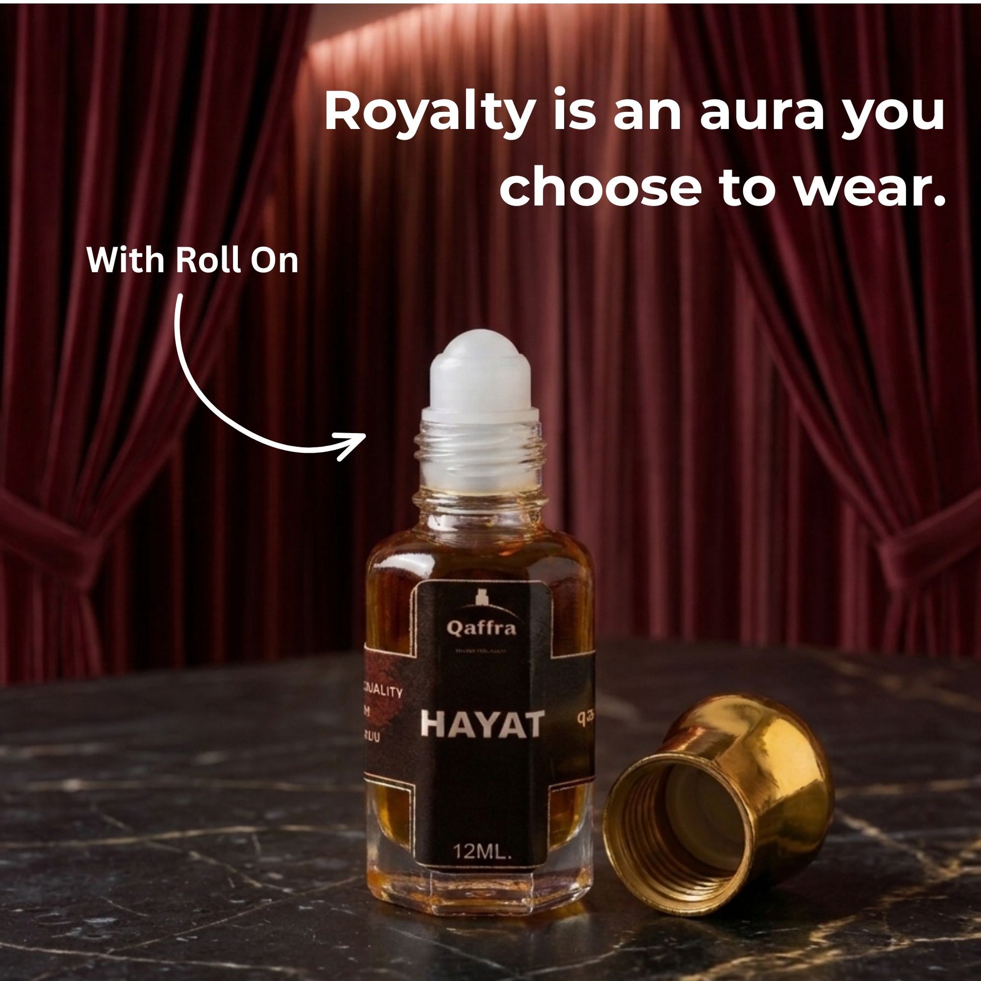 Roll-on bottle of 'Hayat' with a gold cap on a dark surface, red curtain background.