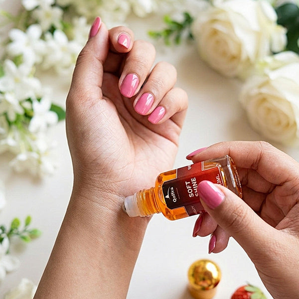 Applying a 12ml Attar bottle of Soft Shine Attar with flowers in the background